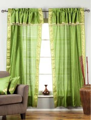Cream sari rod pocket curtains hung at a window