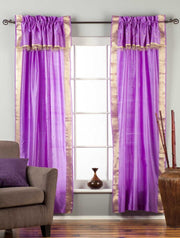 Cream sari rod pocket curtains hung at a window