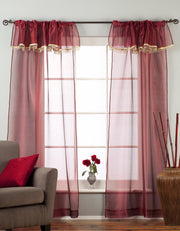 Maroon sheer tissue rod pocket curtains hung at a window