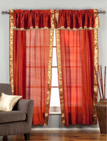 Cream sari rod pocket curtains hung at a window