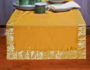 Earthy mustard silk table runner running down a dining table