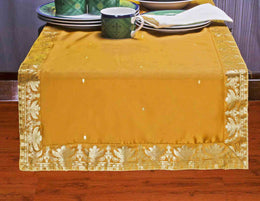 Earthy mustard silk table runner running down a dining table