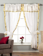 Cream sari rod pocket curtains hung at a window