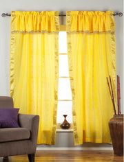Cream sari rod pocket curtains hung at a window