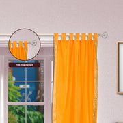 Pumpkin sari tab top curtains hung at a window