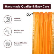Pumpkin sari rod pocket curtains hung at a window