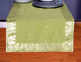 Olive green silk table runner running down a dining table