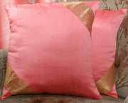 Peach sari cushion covers arranged on a sofa