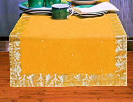 Pumpkin silk table runner running down a dining table