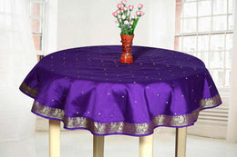 Regal purple sari tablecloth laid on a dining table