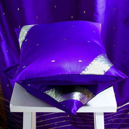 Regal purple sari cushion covers arranged on a sofa