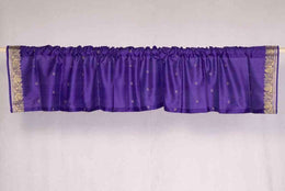 Purple sari valance mounted above a window