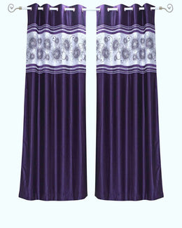 Purple sari grommet top curtains hung at a window