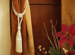 Cream sari curtain tiebacks holding a panel open