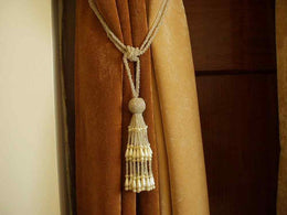 Off white sari curtain tiebacks holding a panel open