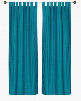 Turquoise velvet tab top curtains hung at a window
