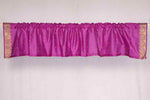 Violet sari valance mounted above a window