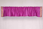 Violet sari valance mounted above a window