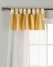 White sheer tissue tab top curtains hung at a window