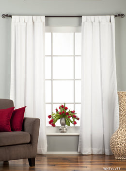White velvet tab top curtains hung at a window