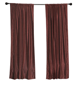 Wine velvet rod pocket curtains hung at a window