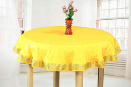 Yellow sari tablecloth laid on a dining table