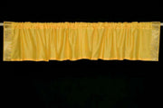 Yellow sari valance mounted above a window