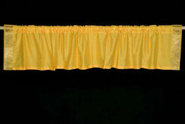 Yellow sari valance mounted above a window